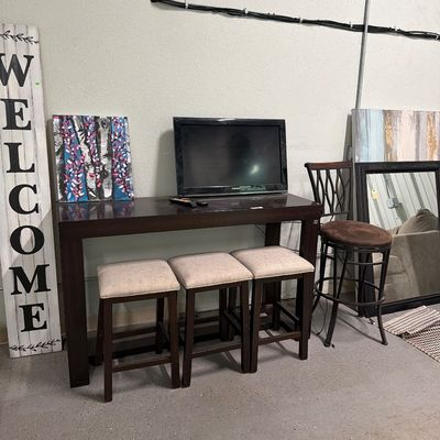 Sale Photo Thumbnail #78: Bar top table with usb plugs, stools mirrors, signs, TV.