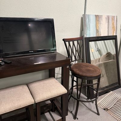 Sale Photo Thumbnail #80: Bar top table with usb plugs, stools mirrors, signs, TV.