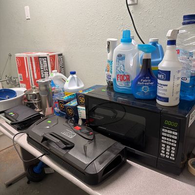Sale Photo Thumbnail #86: Microwave, pots and pans, cleaning supplies and Vacuum sealer.