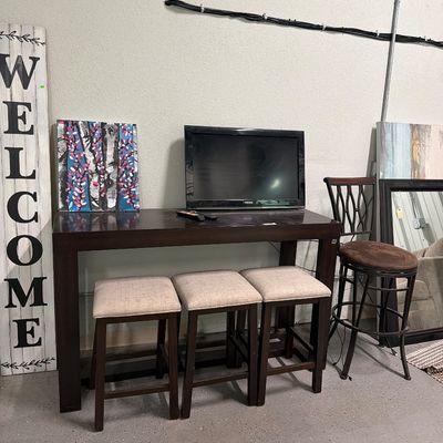 Sale Photo Thumbnail #77: Bar top table with usb plugs, stools mirrors, signs, TV.