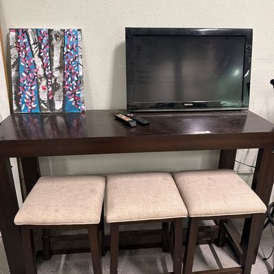 Sale Photo Thumbnail #82: Bar top table with usb plugs, stools mirrors, signs, TV.