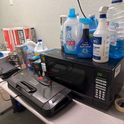 Sale Photo Thumbnail #85: Microwave, pots and pans, cleaning supplies and Vacuum sealer.