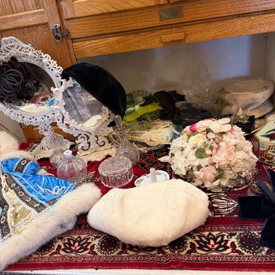 Collection of vintage ladies' accessories including a blue Russian-style souvenir doll, white vanity mirrors, floral pillbox hats,...