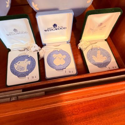 Sale Photo Thumbnail #15: Set of three vintage Wedgwood blue jasperware Christmas medallions in original presentation boxes, featuring relief designs of a rocking horse, bells, and a candle motif.
