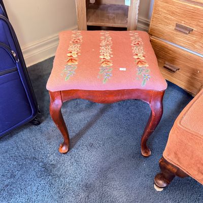 Sale Photo Thumbnail #36: Vintage Queen Anne style footstool featuring cabriole legs and a pink needlepoint padded top with floral stripe details.