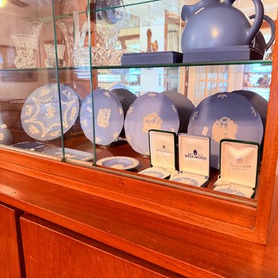 Sale Photo Thumbnail #16: Collection of blue and white Wedgwood Jasperware items including decorative plates, small dishes in original boxes, and cut crystal glassware.