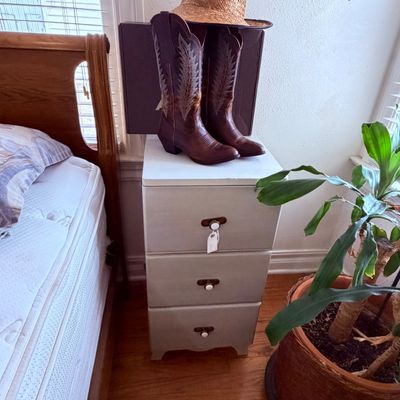 Sale Photo Thumbnail #45: Pair of brown leather cowboy boots, painted three-drawer nightstand