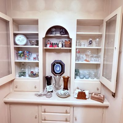 Sale Photo Thumbnail #67: Glassware, owl figurines, decorative plates, and various collectibles.