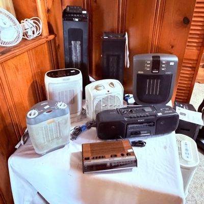 Sale Photo Thumbnail #71: Collection of small household electronics, including various portable space heaters, a Sony boombox, and a vintage GE clock radio