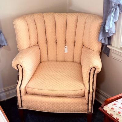 Sale Photo Thumbnail #30: Vintage channel-backed armchair in pale orange patterned upholstery, featuring nailhead trim along the front edges.