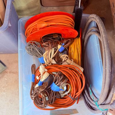 Sale Photo Thumbnail #95: Plastic storage tub filled with an assortment of vintage extension cords, power strips, and heavy-duty electrical cables.