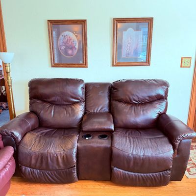 Sale Photo Thumbnail #21: Dark brown leather dual-reclining loveseat with a center storage console and built-in cup holders.