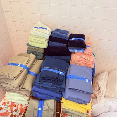 Sale Photo Thumbnail #40: Assorted folded bed sheets, pillowcases, and bath towels