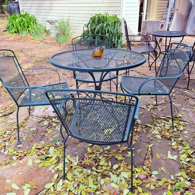Sale Photo Thumbnail #89: Vintage dark green wrought iron mesh patio dining set featuring a round table and four armchairs