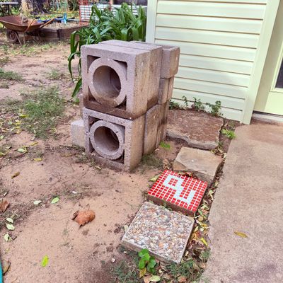 Sale Photo Thumbnail #114: Stack of mid-century modern decorative concrete breeze blocks shown alongside decorative garden stepping stones