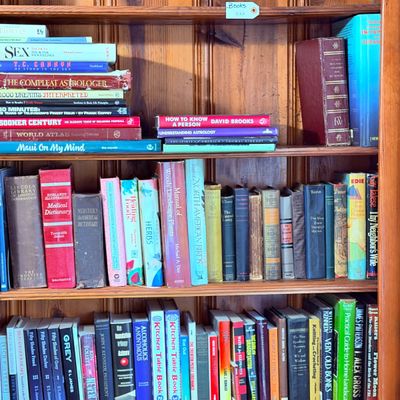 Sale Photo Thumbnail #77: Varied collection of hardcover and paperback books, featuring titles on reference, astrology, fiction, and non-fiction.