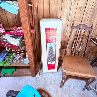 Sale Photo Thumbnail #107: Boxed 7-foot slim cashmere cone tree, wooden dining chair with an upholstered seat.