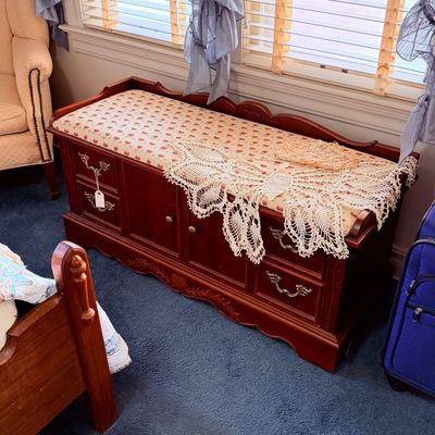 Sale Photo Thumbnail #31: Traditional wooden storage bench with an upholstered padded seat