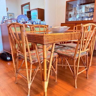 Sale Photo Thumbnail #2: Vintage bamboo and rattan dining set featuring a glass-top table and matching chairs with floral upholstered seats.