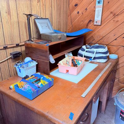 Sale Photo Thumbnail #99: miscellaneous office, craft, and household supplies, including a metal cash box, plastic caddies, and a striped duffel bag.