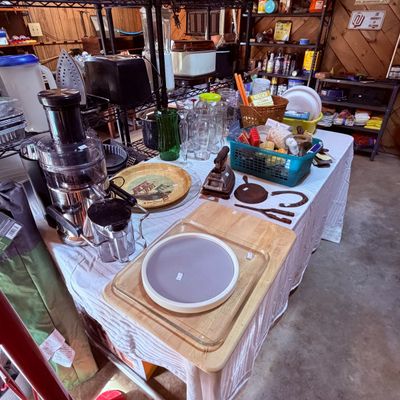 Sale Photo Thumbnail #102: Assorted kitchenware and household goods including an electric juicer, glass baking dishes, glassware, and vintage iron tools.