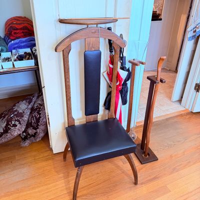 Sale Photo Thumbnail #54: Vintage mid-century wooden valet chair with black vinyl upholstery, built-in coat hanger, and small accessory tray