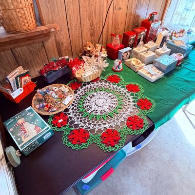 Sale Photo Thumbnail #110: Collection of holiday items featuring a large crocheted red, green, and white doily, boxed greeting cards, small woven baskets with ornaments, and boxed decorations 