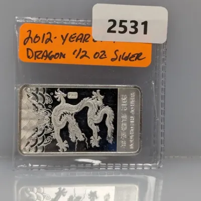 Sale Photo Thumbnail #1022: 2012 Year of the Dragon 1/2 oz silver ingot bar in a protective clear sleeve.