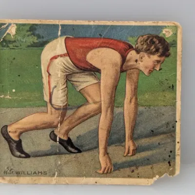 Sale Photo Thumbnail #341: Vintage early 20th-century T222 Hassan Cigarettes sports trading card depicting track athlete R.P. Williams in a runner's stance, showing visible corner wear, creasing, and surface marks.