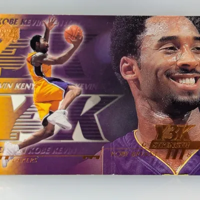 Sale Photo Thumbnail #385: Upper Deck Y2K Kobe Bryant trading card featuring the Los Angeles Lakers guard in an action shot alongside a portrait, in good condition with minor corner wear.