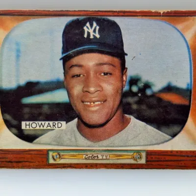 Sale Photo Thumbnail #600: 1955 Bowman Elston Howard baseball card (#84) featuring a television set design border. Shows edge wear and light surface marks typical for its age.