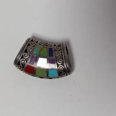 Sale Photo Thumbnail #987: Sterling silver curved slide pendant featuring colorful mosaic inlay including turquoise, lapis, coral, and mother of pearl with filigree scroll side details.