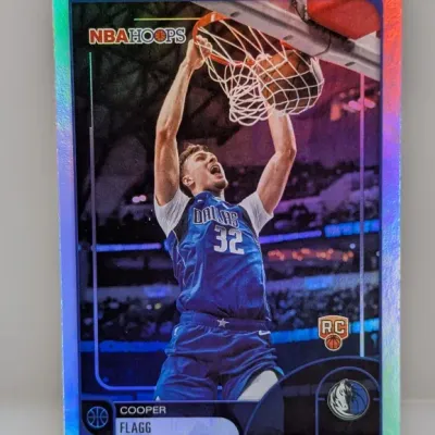 Sale Photo Thumbnail #240: Cooper Flagg NBA Hoops rookie basketball trading card featuring a holographic foil border and in-action dunk photography.
