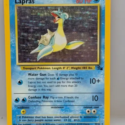 Sale Photo Thumbnail #210: 1999 Pokémon Fossil set Lapras holographic card #10/62 in played condition with visible surface scuffing.