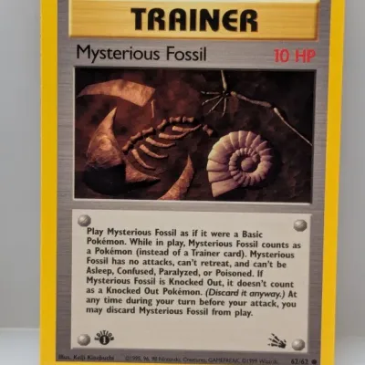Sale Photo Thumbnail #802: 1st Edition Pokémon Fossil set Mysterious Fossil Trainer card, #62/62, copyrighted 1999 Wizards of the Coast.