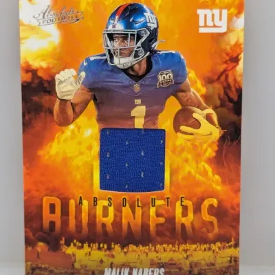 Sale Photo Thumbnail #941: Panini Absolute Football 'Absolute Burners' Malik Nabers memorabilia trading card featuring an embedded blue jersey swatch.