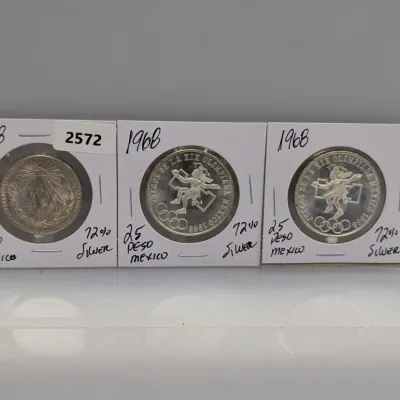 Sale Photo Thumbnail #1068: Trio of Mexican silver coins in cardboard flips, including a 1938 Un Peso and two 1968 Mexico Olympics 25 Pesos 72% silver coins.