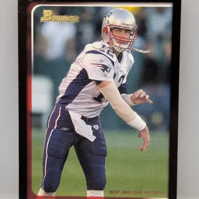 Sale Photo Thumbnail #287: Tom Brady Bowman New England Patriots football trading card featuring black borders and gold foil lettering.
