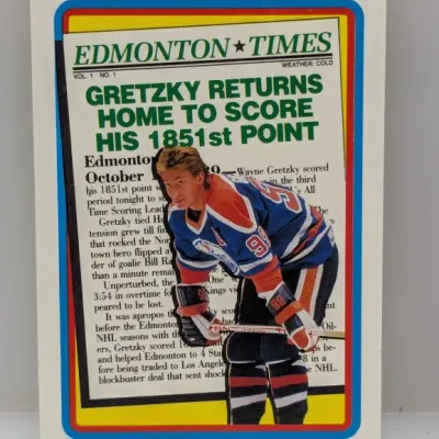 Sale Photo Thumbnail #745: 1990 Upper Deck Wayne Gretzky trading card, #3 highlighting his 1,851st NHL point record, featuring an Edmonton Times newspaper headline background.