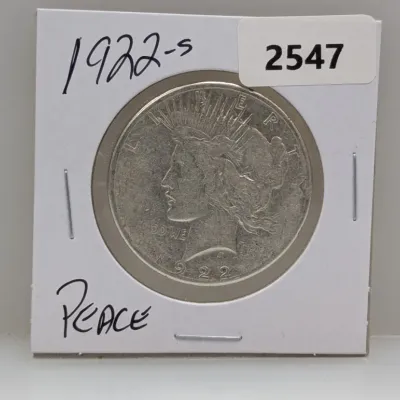 Sale Photo Thumbnail #1038: 1922-S Peace silver dollar coin in a cardboard flip holder.
