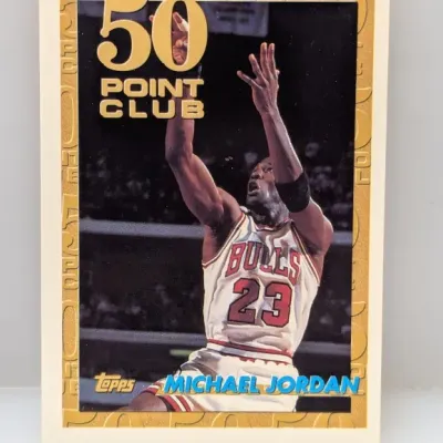 Sale Photo Thumbnail #691: 1993-94 Topps Michael Jordan "50 Point Club" basketball card, #205, featuring gold foil lettering and border details.