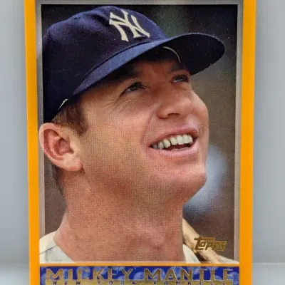 Sale Photo Thumbnail #927: Topps Mickey Mantle baseball card featuring a yellow border and silver foil details.