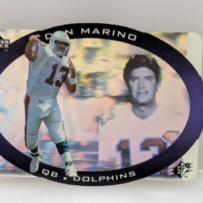 Sale Photo Thumbnail #739: 1996 Upper Deck SPx Dan Marino holographic trading card, featuring a die-cut oval design and holographic action image.