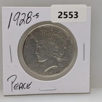 Sale Photo Thumbnail #1044: 1928-S Peace silver dollar coin in a protective cardboard flip holder.