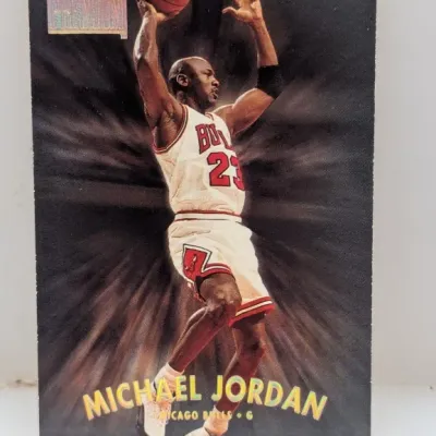 Sale Photo Thumbnail #686: 1997-98 SkyBox Premium Michael Jordan basketball card #28, featuring holographic gold foil lettering and a dark action background.