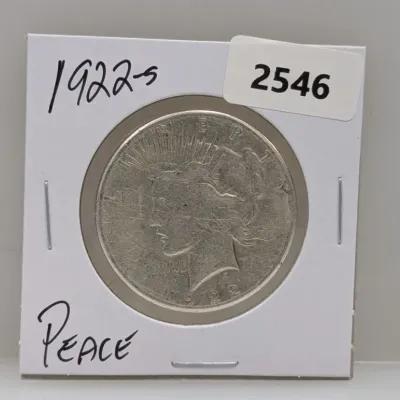 Sale Photo Thumbnail #1037: 1922-S Peace silver dollar coin in a cardboard flip holder.