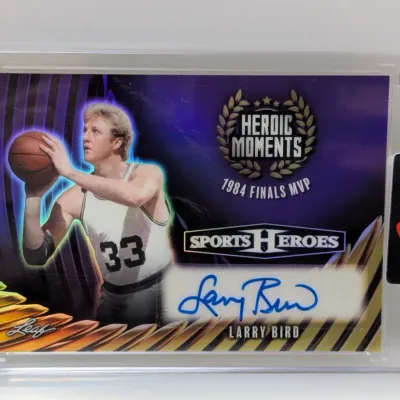 Sale Photo Thumbnail #27: Leaf Sports Heroes Larry Bird autographed trading card, featuring a '1984 Finals MVP Heroic Moments' design and enclosed in a protective hard plastic case with a Leaf seal.
