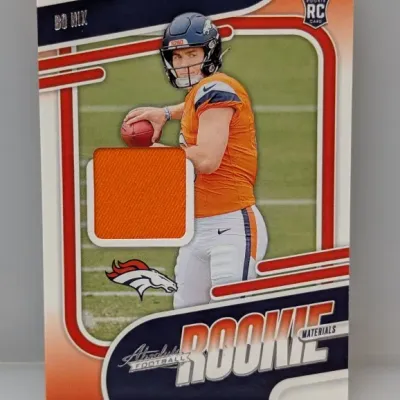 Sale Photo Thumbnail #368: Panini Absolute Football Bo Nix Rookie Materials trading card featuring an embedded orange jersey relic swatch.