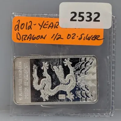 Sale Photo Thumbnail #1023: 2012 Year of the Dragon 1/2 oz fine silver bar, encased in a protective plastic flip.