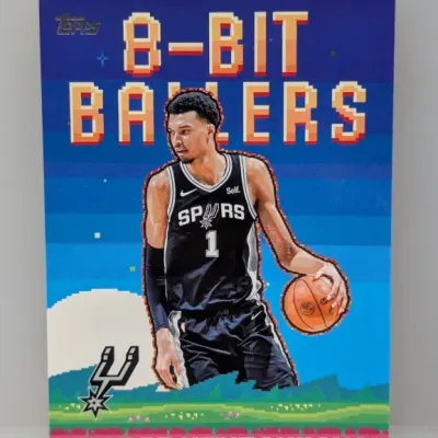 Sale Photo Thumbnail #311: 2023-24 Topps '8-Bit Ballers' Victor Wembanyama insert trading card featuring a pixel-art retro video game style background.